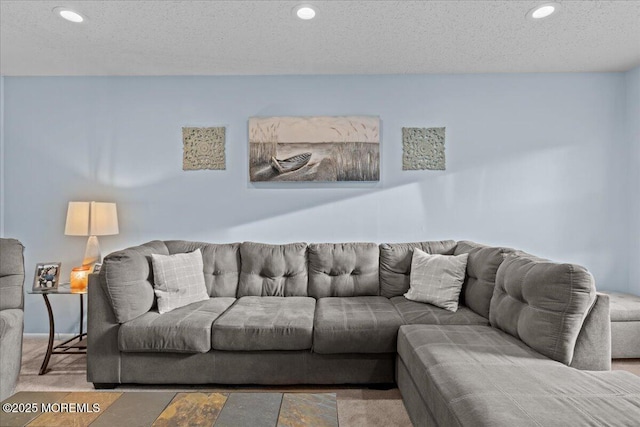 living room with carpet floors, recessed lighting, and a textured ceiling