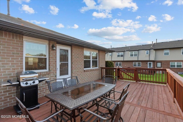 deck featuring a grill and outdoor dining space