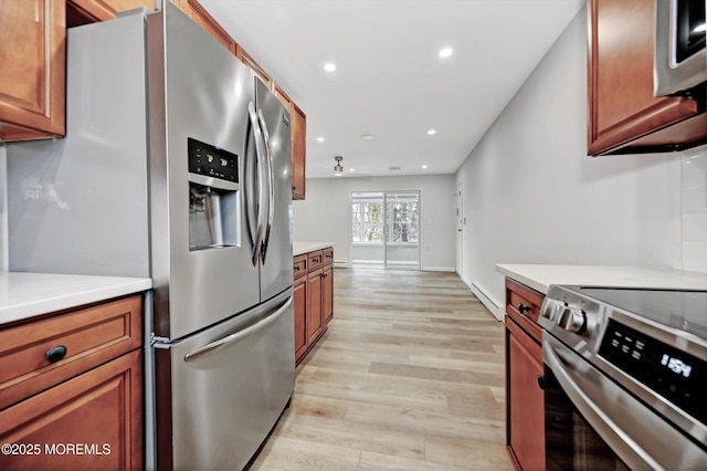 kitchen with light wood-style flooring, recessed lighting, stainless steel appliances, light countertops, and brown cabinetry