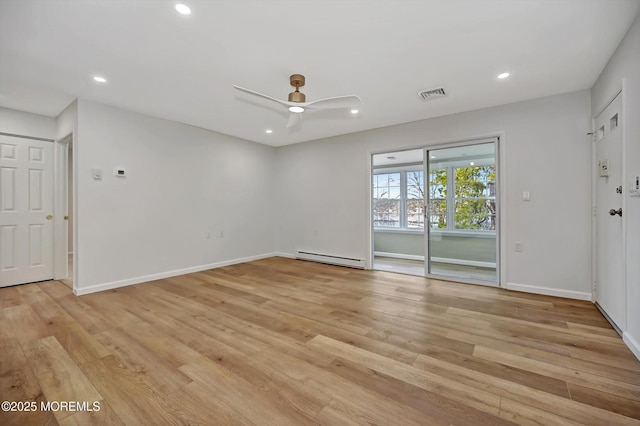 unfurnished room featuring a baseboard heating unit, recessed lighting, visible vents, and light wood-style floors