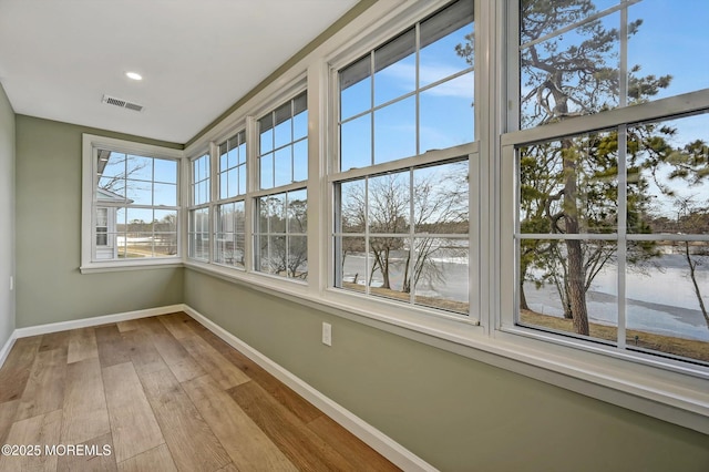 unfurnished sunroom with visible vents