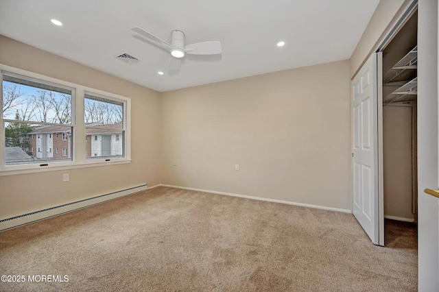 unfurnished bedroom with visible vents, baseboard heating, carpet flooring, and recessed lighting