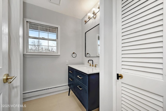 bathroom with baseboards, baseboard heating, vanity, and tile patterned floors