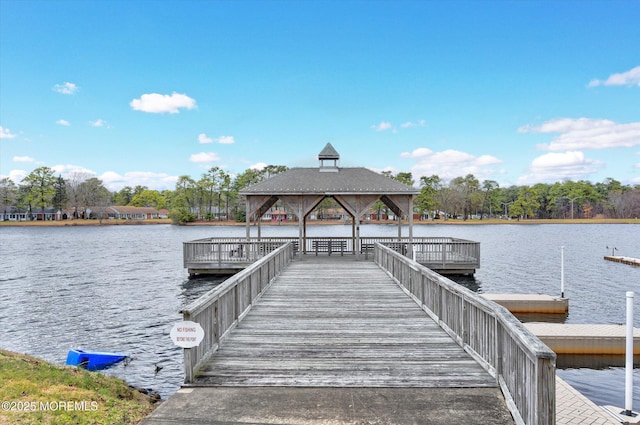 dock area with a gazebo and a water view