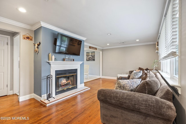 12 Edgewater Dr, Matawan, NJ 07747 - living area with a glass covered fireplace, recessed lighting, wood finished floors, baseboards, and ornamental molding