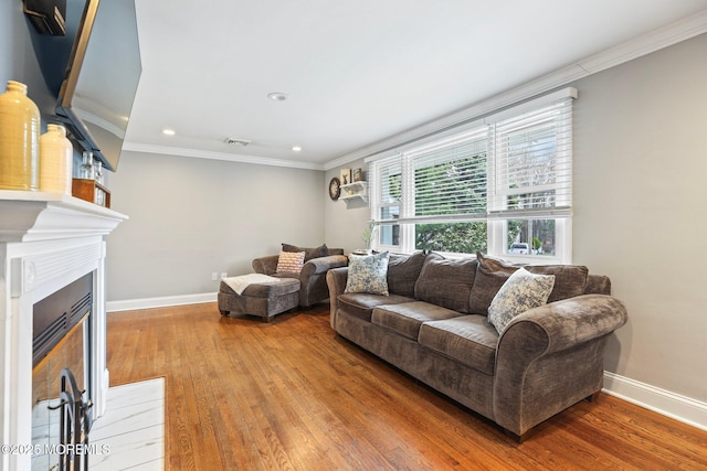 12 Edgewater Dr, Matawan, NJ 07747 - living area with ornamental molding, baseboards, wood finished floors, recessed lighting, and a fireplace with flush hearth