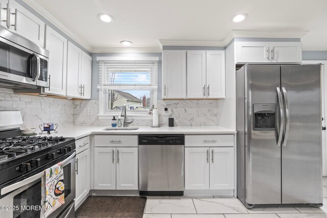 12 Edgewater Dr, Matawan, NJ 07747 - kitchen featuring stainless steel appliances, a sink, ornamental molding, light countertops, and white cabinetry