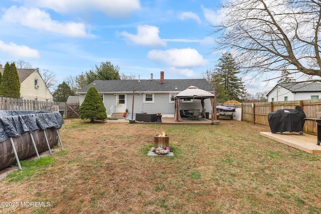 12 Edgewater Dr, Matawan, NJ 07747 - rear view of house with a gazebo, entry steps, a patio, and a chimney