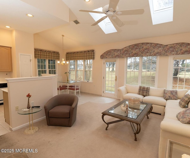 living area featuring light carpet, visible vents, lofted ceiling with skylight, ceiling fan with notable chandelier, and recessed lighting