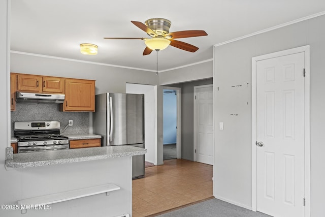 kitchen with tasteful backsplash, light colored carpet, ornamental molding, ceiling fan, and stainless steel appliances