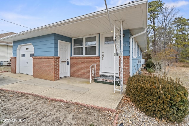 view of front of home featuring cooling unit and a garage