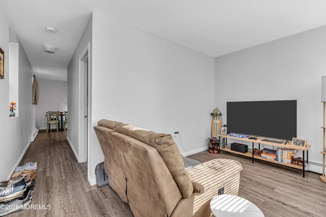 living room with wood-type flooring and baseboard heating