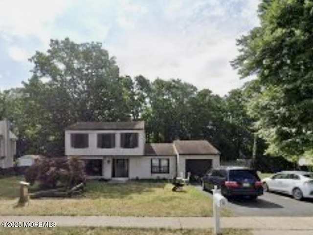 view of front of home with a garage and a front yard