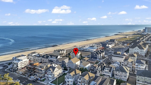 bird's eye view featuring a view of the beach and a water view