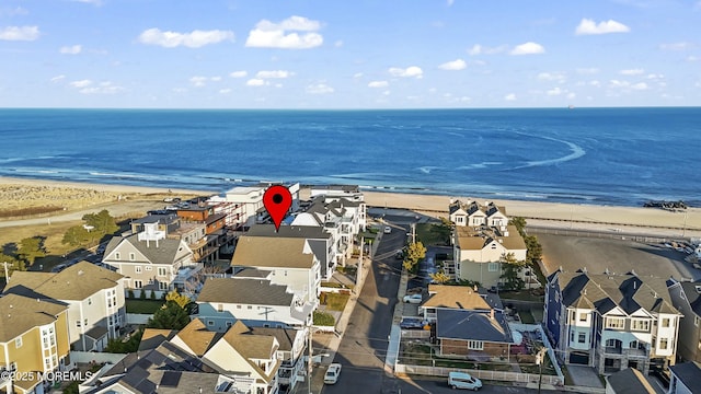 aerial view with a water view and a beach view