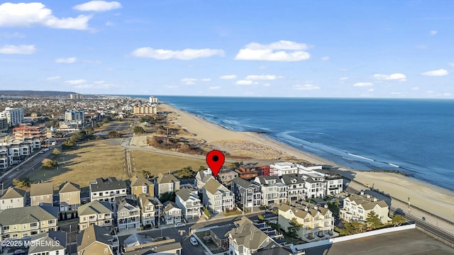 birds eye view of property featuring a water view and a beach view