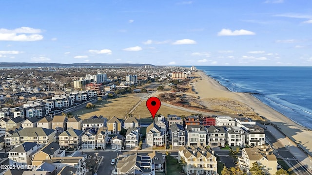 drone / aerial view featuring a view of the beach and a water view