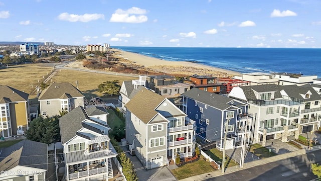 bird's eye view with a water view and a view of the beach