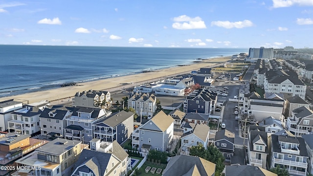 birds eye view of property featuring a water view and a beach view