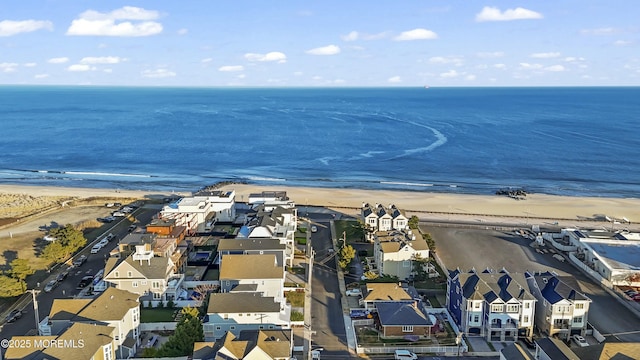 birds eye view of property with a beach view and a water view