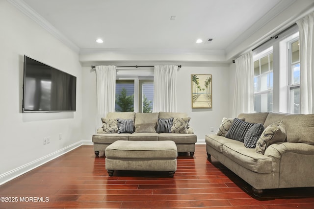 living room featuring ornamental molding, a healthy amount of sunlight, and dark hardwood / wood-style flooring