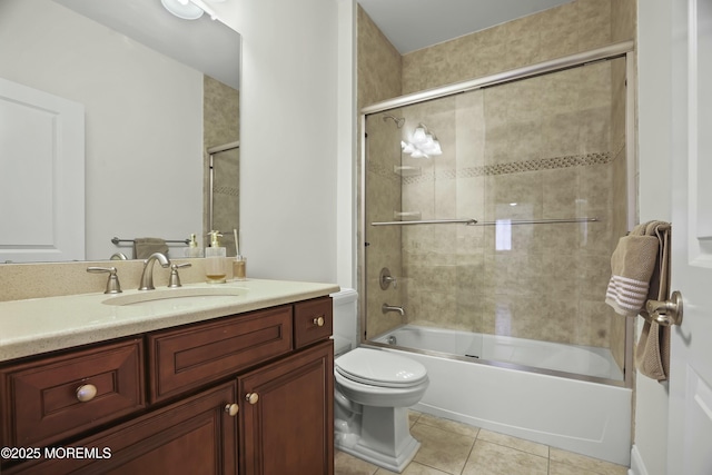 full bathroom featuring toilet, tile patterned floors, bath / shower combo with glass door, and vanity