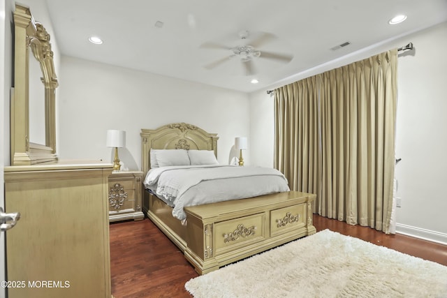 bedroom with dark hardwood / wood-style floors and ceiling fan