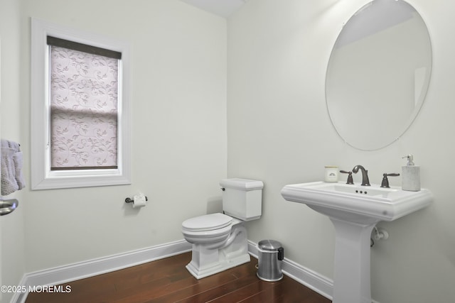 bathroom featuring hardwood / wood-style floors and toilet