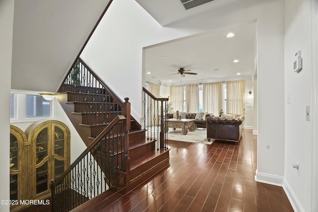 staircase featuring hardwood / wood-style flooring and ceiling fan