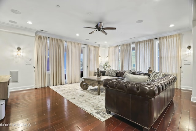 living room with crown molding, ceiling fan, and dark hardwood / wood-style floors