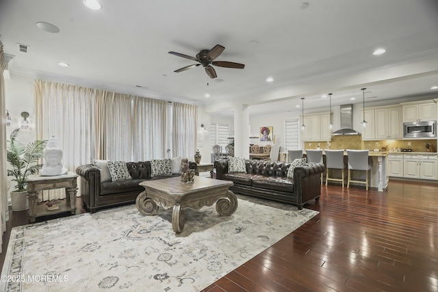 living room featuring ornamental molding, dark hardwood / wood-style floors, and ceiling fan