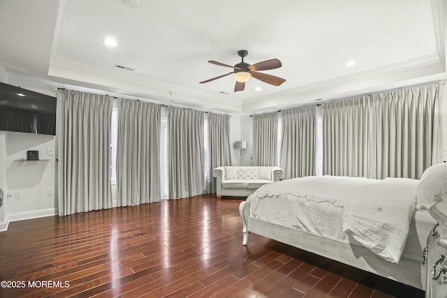 bedroom featuring a raised ceiling, crown molding, dark hardwood / wood-style floors, and ceiling fan