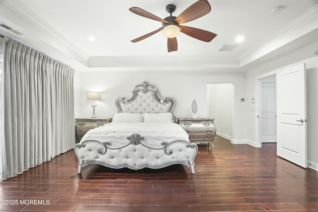 bedroom featuring a raised ceiling, crown molding, and dark hardwood / wood-style flooring