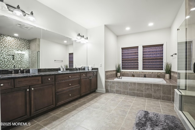 bathroom featuring tile patterned flooring, vanity, and separate shower and tub