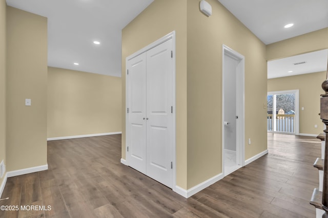 hallway with hardwood / wood-style flooring