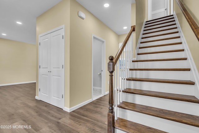 staircase with hardwood / wood-style floors