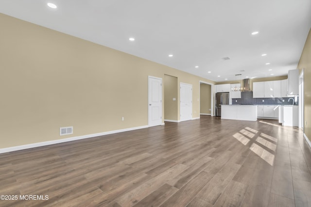 unfurnished living room with hardwood / wood-style flooring