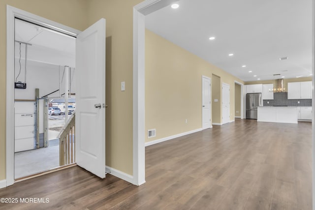 unfurnished living room with dark wood-type flooring