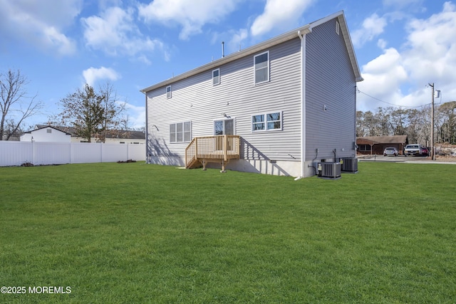 back of property featuring a yard and cooling unit