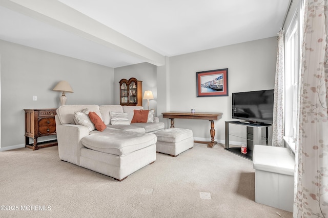 living room featuring beamed ceiling and carpet flooring