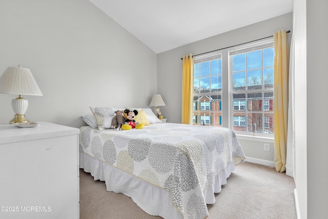 bedroom with light colored carpet and lofted ceiling