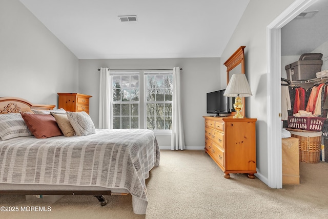 bedroom with lofted ceiling and light carpet