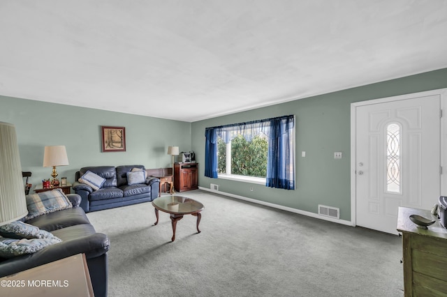 living area featuring carpet, visible vents, and baseboards