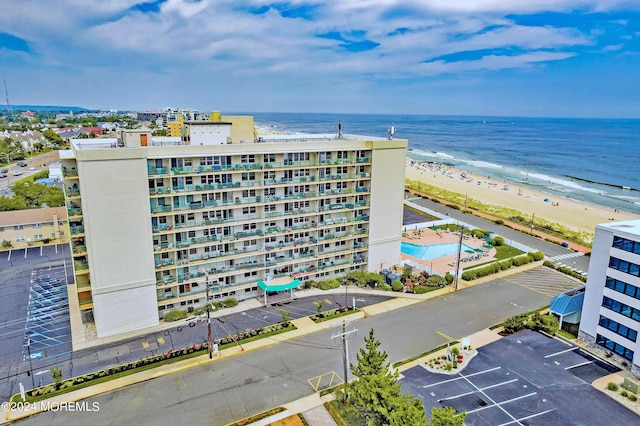 bird's eye view featuring a water view and a beach view