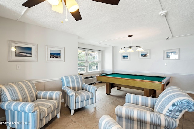 game room featuring light tile patterned floors, a textured ceiling, pool table, a ceiling fan, and a wall mounted air conditioner