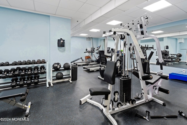 exercise room with a paneled ceiling