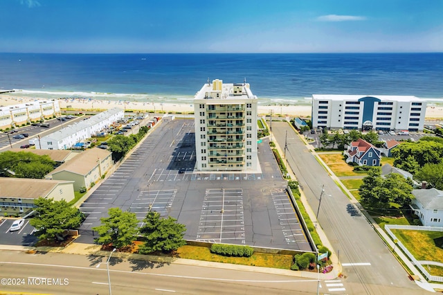 aerial view with a water view and a beach view