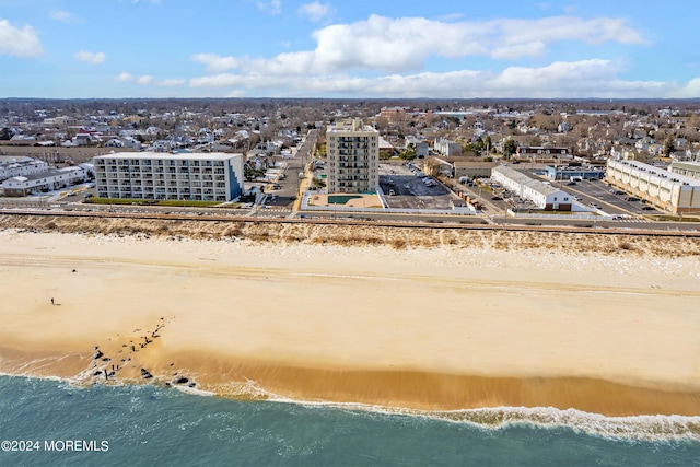 bird's eye view featuring a view of the beach and a water view