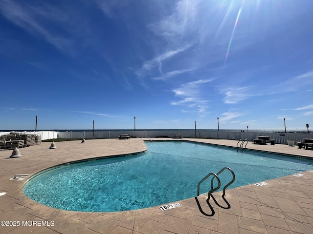 community pool featuring a patio and fence