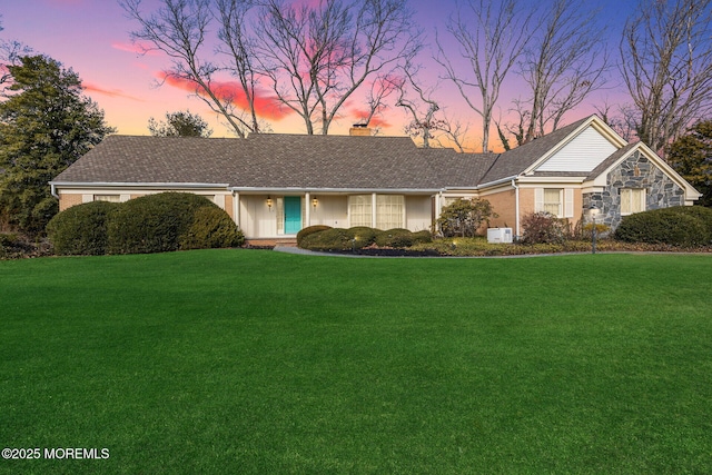 ranch-style house with a lawn